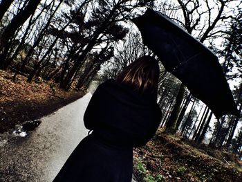 Person standing on tree trunk