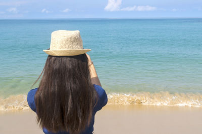 Rear view of woman looking at sea