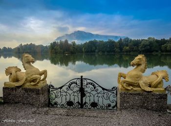 Scenic view of lake by mountain against sky