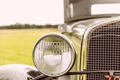 Close-up of vintage car on field