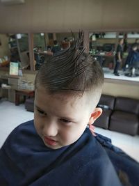 Close-up of boy sitting in hair salon 