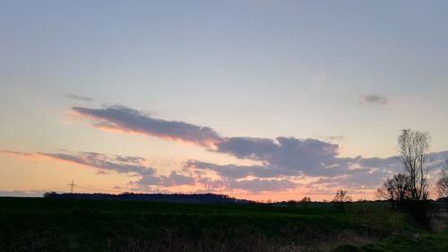 Scenic view of field against sky during sunset