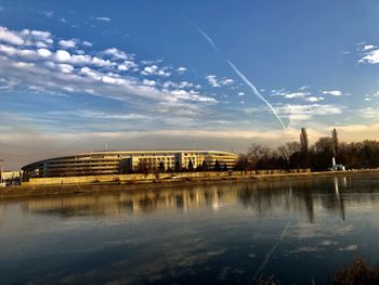 Reflection of buildings in lake against sky