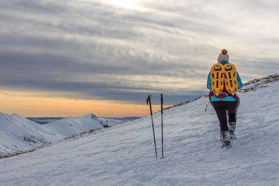 Girl with backpack in the mountains with snow. lifestyle concept