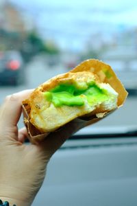 Close-up of hand holding burger