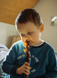 Close-up of boy playing guitar