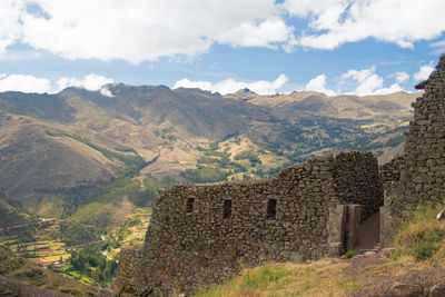 Scenic view of mountains against cloudy sky