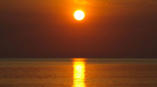 Scenic view of sea against orange sky