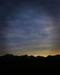 Scenic view of silhouette mountains against sky at sunset