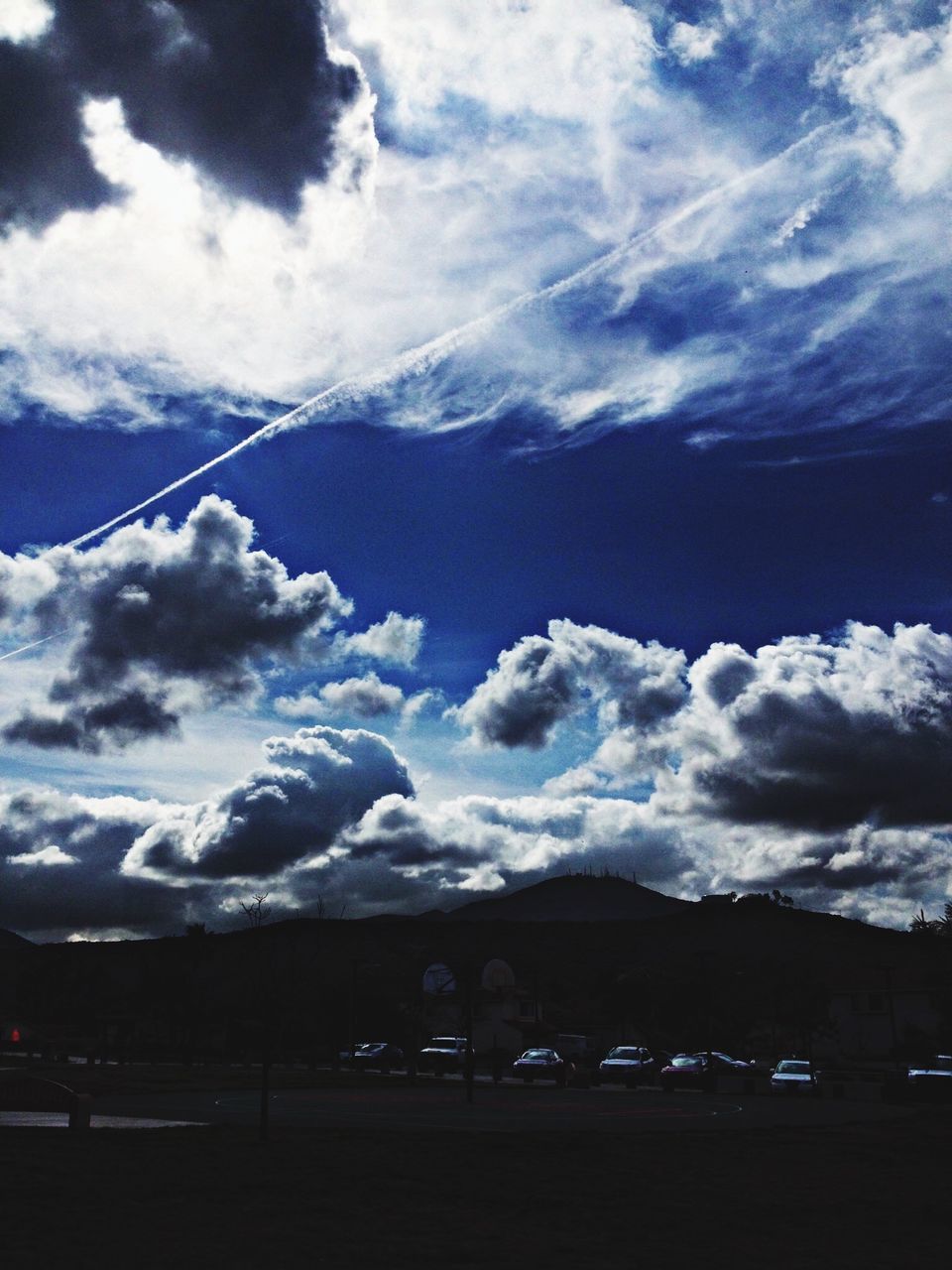 sky, cloud - sky, cloud, cloudy, scenics, nature, beauty in nature, mountain, low angle view, weather, day, cloudscape, blue, tranquility, outdoors, no people, tranquil scene, majestic, idyllic, transportation