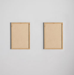 Close-up of clothes hanging on white wall