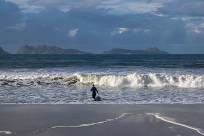 People on beach against sky