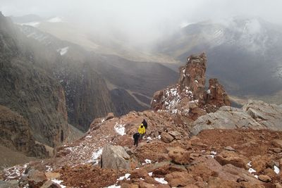 Rear view of people walking on mountain