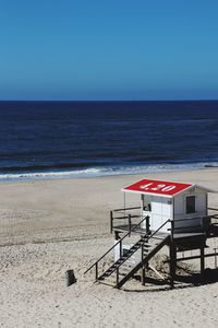 Lifeguard hut on beach against clear sky