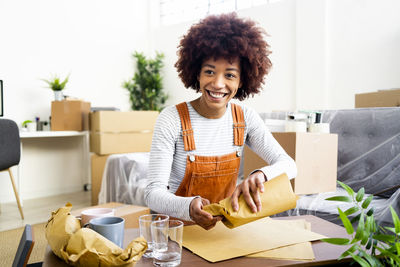 Portrait of smiling woman sitting at table