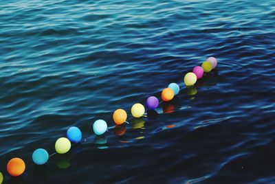 High angle view of multi colored floating on swimming pool