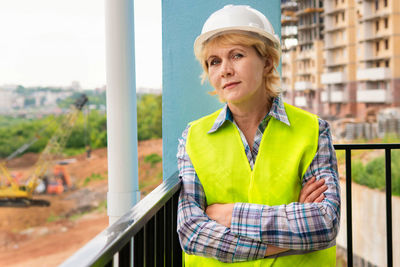 Portrait of a young woman standing at construction site