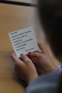 Midsection of woman holding text on paper