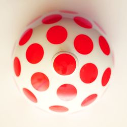 Close-up of red object over white background