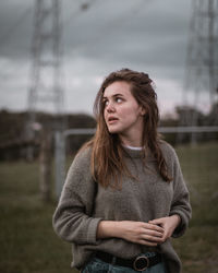 Portrait of beautiful young woman standing outdoors