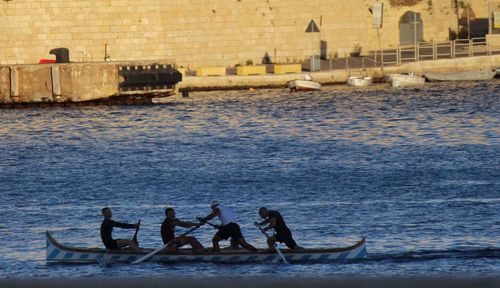 People on boats in sea