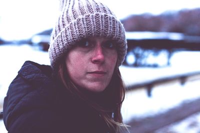 Close-up portrait of young woman during winter