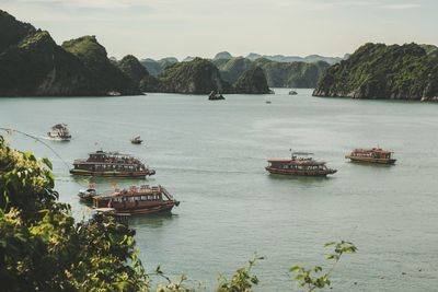 Boats sailing in river against sky