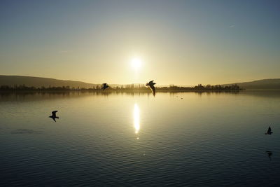 Scenic view of lake against sky during sunset