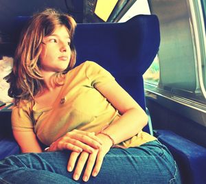 Rear view of woman sitting in train