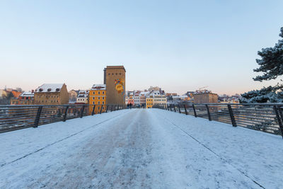 View of buildings in city against clear sky