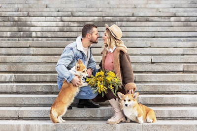 A couple in love on a date in the park. a blonde in a hat and a man look at each other.