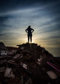 Silhouette of a woman standing against sky