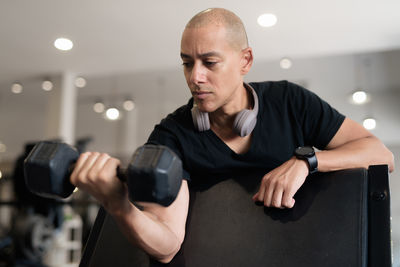Muscular man exercising in gym