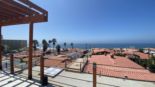 Buildings by swimming pool against clear sky