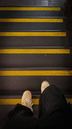 Low section of man standing on steps