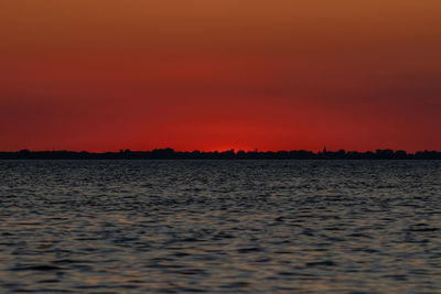 Scenic view of sea against romantic sky at sunset