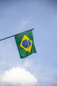Low angle view of brazilian flag against sky.