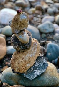 Close-up of stone stack on rock at beach