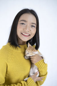 Portrait of a smiling young woman over white background