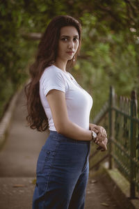 Portrait of smiling young woman standing outdoors