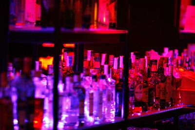 Illuminated bottles on display at store