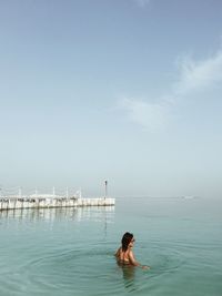 Woman standing by sea