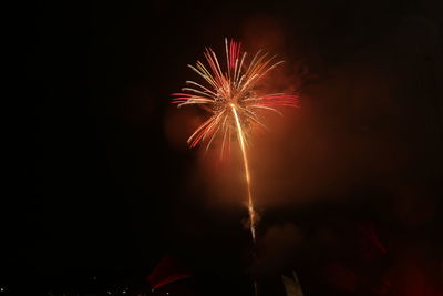 Low angle view of firework display at night