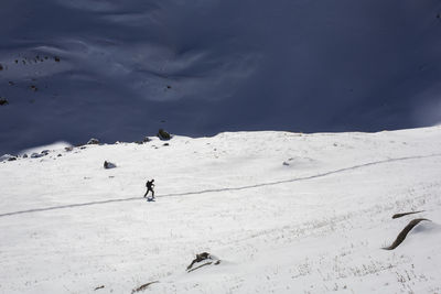 High angle view of people skiing on snow covered land