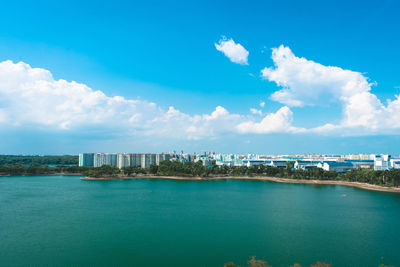 Panoramic view of sea and buildings against sky