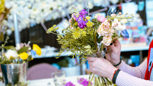 Close-up of hand holding bouquet of flower