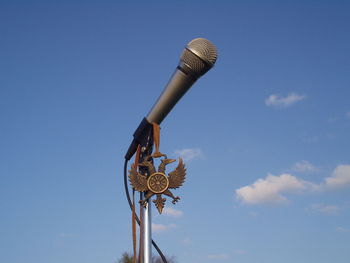 Low angle view of communications tower against blue sky