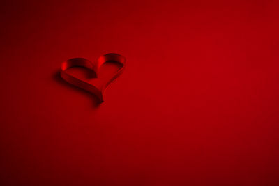 Close-up of heart shape on red background