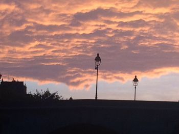 Silhouette street light against sky during sunset