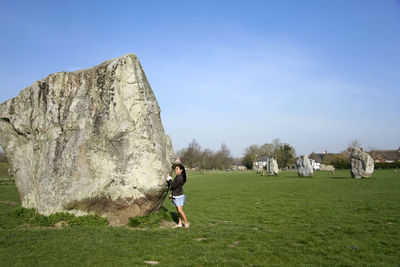 Full length of woman on rocks against sky